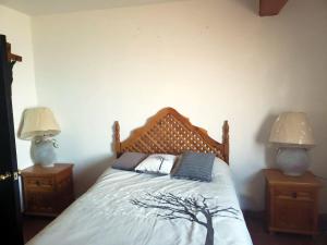 a bedroom with a bed with two lamps on either side at Casa Vista Taxco in Taxco de Alarcón