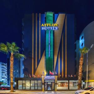 a hotel with a sign that reads atrium hotels at Afflon Hotels Loft City in Antalya