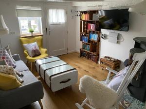 a living room with a couch and a chair at Hübingen Cottage in Hübingen