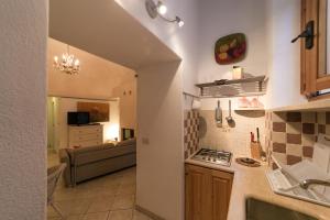 a kitchen and a living room with a couch at NICE APARTMENT in Porto Santo Stefano +9 photos