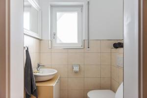 a bathroom with a sink and a toilet and a window at Zauberhaft im Naturpark Altmühltal in Greding