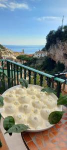 a plate of food on a table on a balcony at La Valle Delle Ferriere in Amalfi