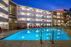 a swimming pool in front of a building at La Quinta by Wyndham Pomona in Pomona