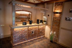 a brick bar in a restaurant with a brick wall at Ašmonienės svečių namai "Senoji mokyklėlė" in Smalininkai +50 photos