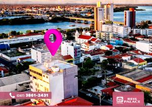 a pink symbol is on top of a city at Reis Palace Hotel in Petrolina