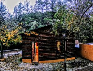 a small log cabin with a street light next to it at Cabañas Jimera de Líbar in Jimera de Líbar