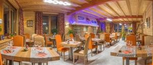 a restaurant with tables and chairs in a room at ALPAZUR Val Cenis in Lanslebourg-Mont-Cenis