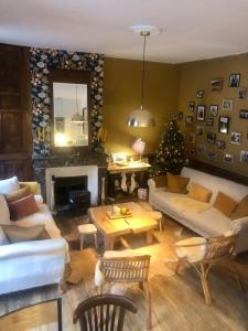 a living room with a couch and a christmas tree at Appartement Joséphine in Eaux-Bonnes
