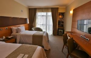 Cama ou camas em um quarto em Bourbon Santos Convention Hotel