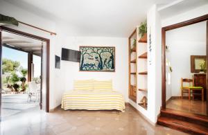 a white room with a bed and a doorway at Residence del Sole in Lampedusa