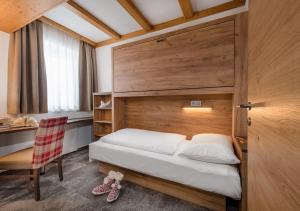 Łóżko lub łóżka w pokoju w obiekcie Apartments & Garni Alpenrose