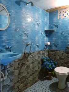 a blue bathroom with a sink and a toilet at Agonda Holiday Home in Agonda