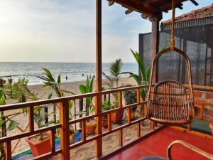 a balcony with a view of the beach at Agonda Holiday Home in Agonda