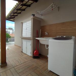 a bathroom with a sink and a large window at Loft encantador B - 8 km de Floripa in São José