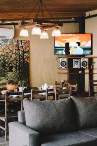 a living room with a couch and a television at Elena Hostel in Tandil