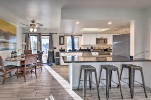 a kitchen and living room with a table and chairs at Cozy Home with Large Yard, 2 Mi to Lake Havasu! in Lake Havasu City