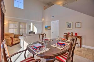 a living room with a table and chairs at Sunny San Tan Valley Home with Grill on Golf Course! in Magma