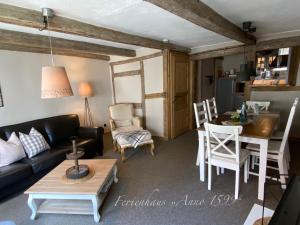 a living room with a couch and a table at Ferienhaus Anno 1599 in Wernigerode +13 photos