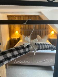 a bed with a black and white bow on it at Ferienhaus Anno 1599 in Wernigerode
