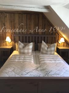 a bedroom with a bed with a sign on it at Ferienhaus Anno 1599 in Wernigerode