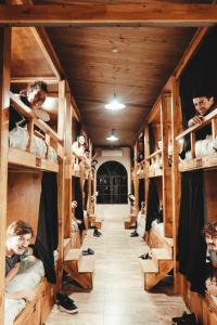 a room full of bunk beds with people in them at Elena Hostel in Tandil