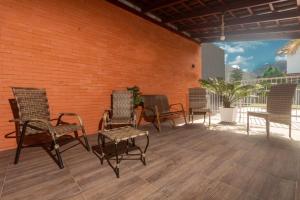 a group of chairs and tables on a patio at Pousada Morada da Praia - Balneário Camboriú in Balneário Camboriú
