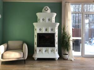 コストロマにあるGuest house Dalnyaya 11のリビングルーム(白い暖炉、椅子付)