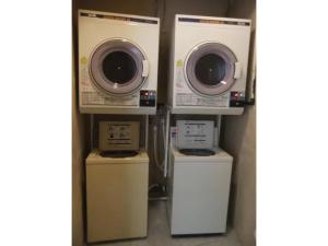 a laundry room with two dry machines and a washer at Hotel Kokusai Plaza - Vacation STAY 09920v in Naha