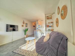 een woonkamer met een bank en een tafel bij Appartement bord de mer Biarritz in Biarritz