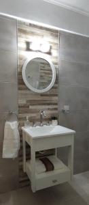 a bathroom with a sink and a mirror at Departamento centro mdp calle belgrano in Mar del Plata