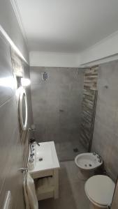 a bathroom with a sink and a toilet and a shower at Departamento centro mdp calle belgrano in Mar del Plata