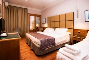 Cama ou camas em um quarto em Hotel Giolli Nazionale