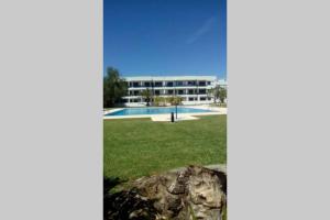 a building with a swimming pool in a field at Marina Mar in Vilamoura downtown in Quarteira