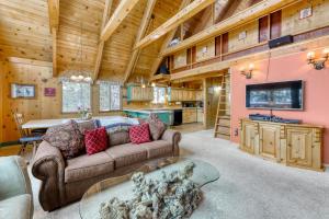 a living room with a couch and a tv at Serene Escape in Soda Springs