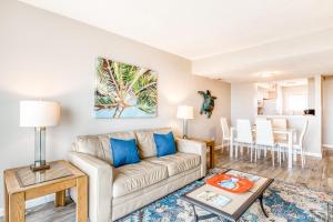 a living room with a couch and a table at Tybee Lights in Tybee Island
