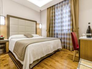 Cama ou camas em um quarto em Hotel Giolli Nazionale