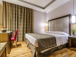 Cama ou camas em um quarto em Hotel Giolli Nazionale