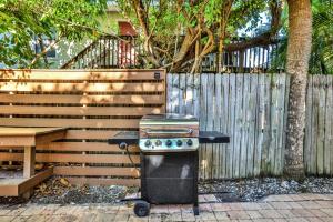 a barbecue grill sitting in front of a fence at Sunrise Garden Resort in Anna Maria
