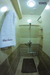 a bathroom with a shower with a towel at Hostel Buston in Chkalovsk