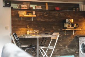 a table with wine glasses on it in a kitchen at Gîte Le Petit Arbizon in Campan