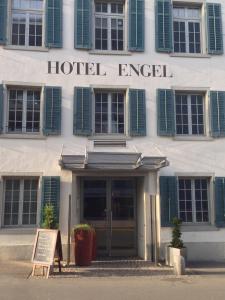 a hotel entrance with a sign in front of it at Hotel Engel am Bahnhof in Wädenswil