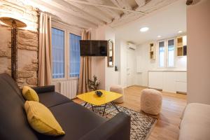 a living room with a couch and a table at Cosy home in Paris Center - With AC in Paris