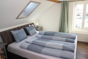a bedroom with a large bed with blue pillows at Ferienhaus Kluser in Oberriet
