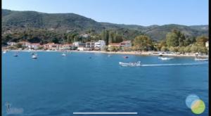 a group of boats in the water near a beach at Harmony Seaside Pelion in Platanias