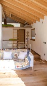1 dormitorio con cama y techo de madera en b&bTerre Aromatiche, en Chiesa in Valmalenco