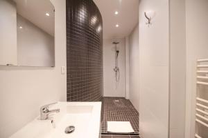 a white bathroom with a sink and a shower at Lovely Home in Paris Center - AC in Paris