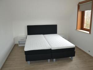 a bedroom with a bed in a room with a window at Welcoming Villa in Puivelde with Terrace Garden Barbeque in Puivelde