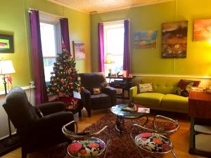 a living room with a christmas tree in it at The Muse Gallery Guesthouse in Milwaukee