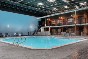 a large swimming pool in the middle of a building at Copper King Extended Stay Collection in Butte