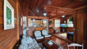 a living room with a couch and a table at Chales Edelweiss in Visconde De Maua